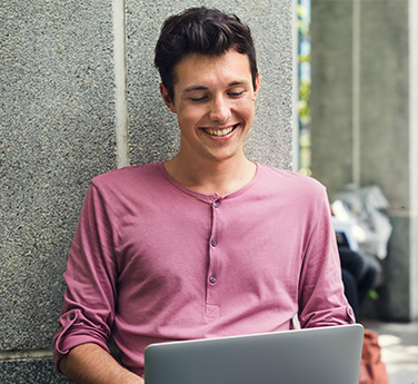 Meet community where they are - man using laptop outside