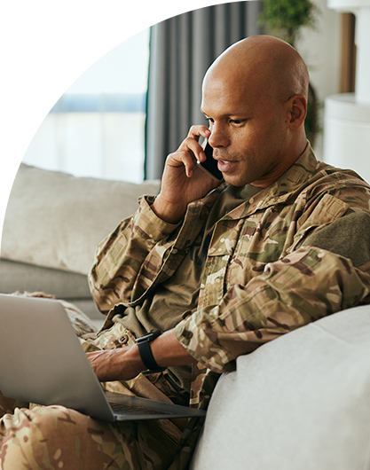 Man in military uniform on laptop