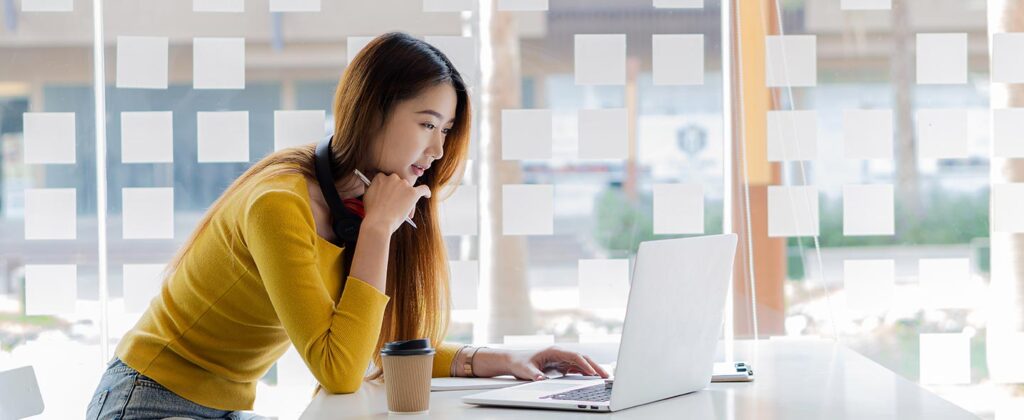 Woman at counter on laptop