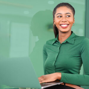 Woman in a green shirt on her computer, depicting data-driven insights