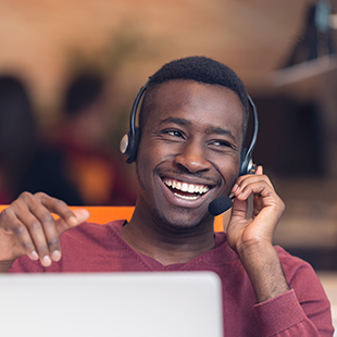 Smiling man working with support team